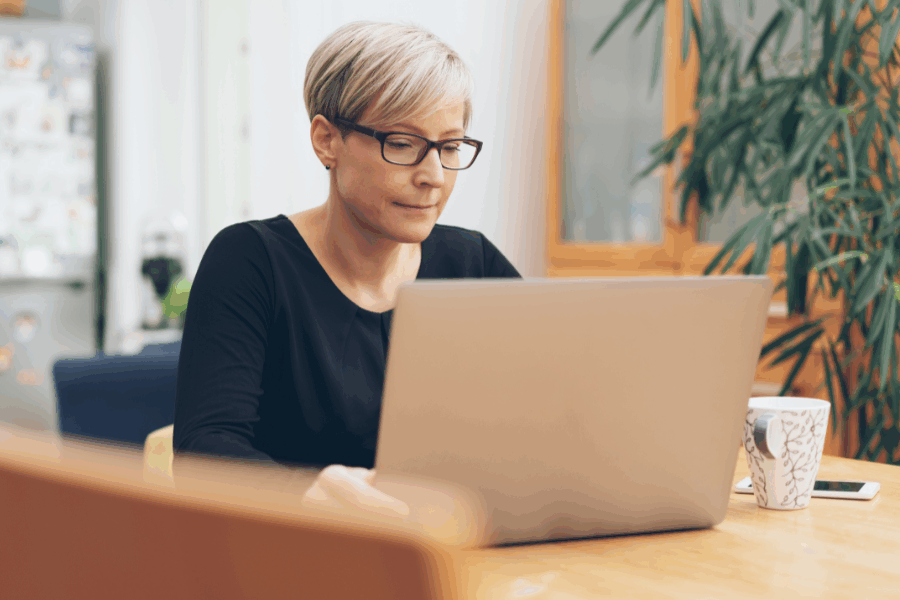 Middle aged woman sat at her laptop working
