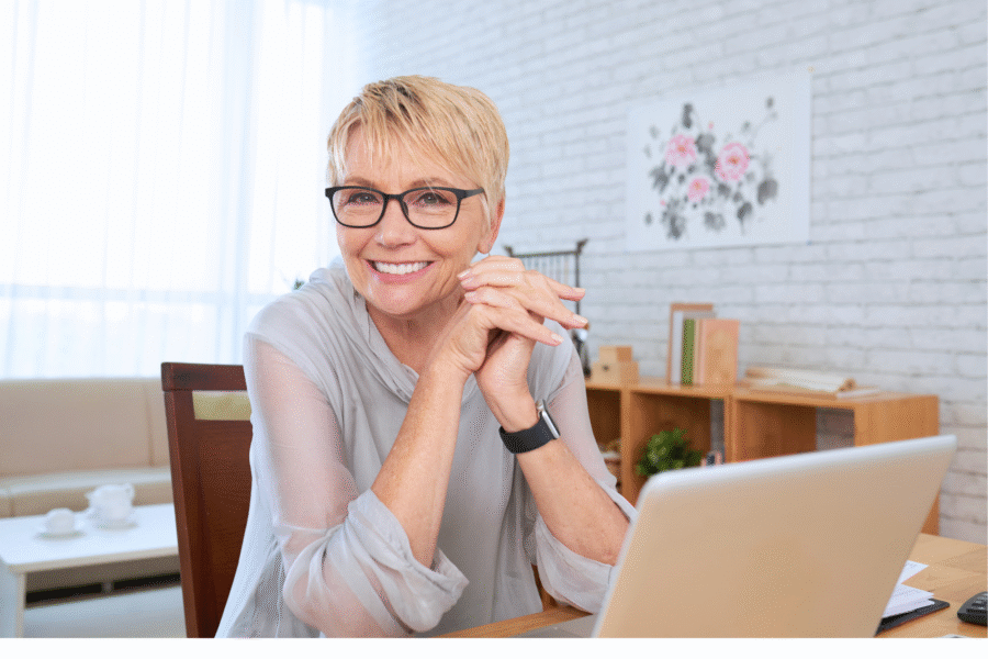 A woman sitting at a desk smiling